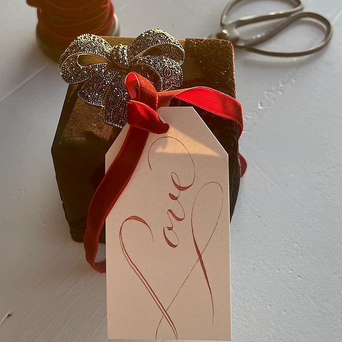 An engagment gift featuring our love gift tag in ruby ink with a vibrant velvet ribbon. It has its own love note on the back of the tag.
