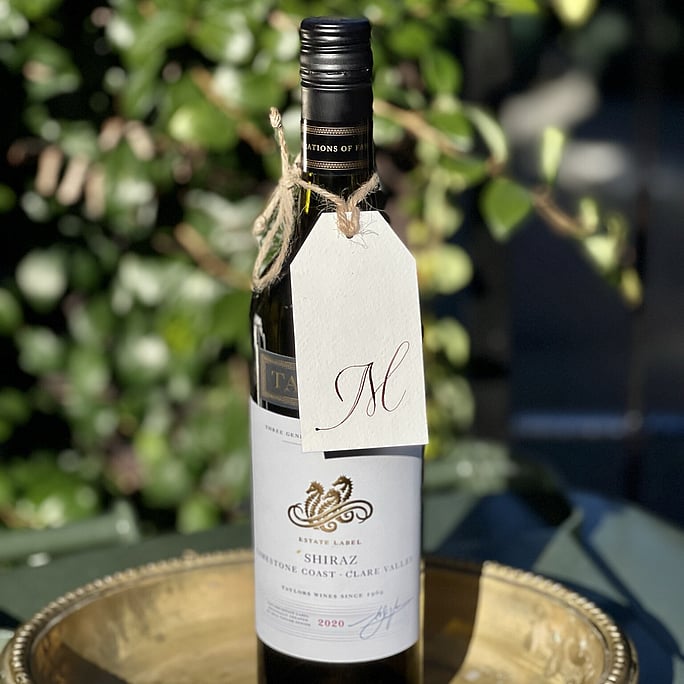 An M gift tag for Murray attached to a shiraz his favourite red wine