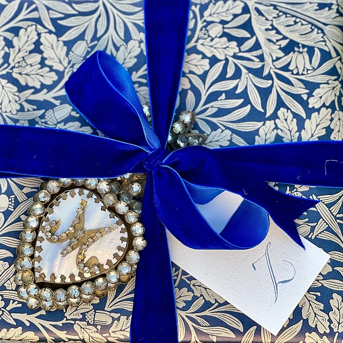 A gift wrapped in a william morris print with a vibrant blue velvet ribbon. Finished with a Z gift tag, a gift for Zayna - happy graduation
