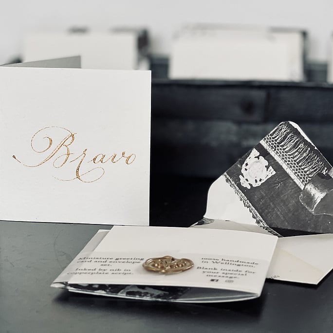 Our bravo mini card and envelope set sitting in from of a collection of our minis. Shows our unique envelopes handmade from recycled books