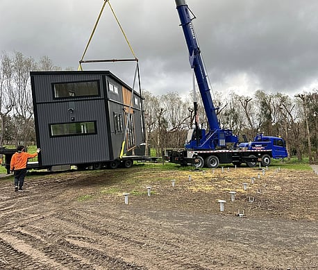 Tiny Towing Solutions work with crane companies to help get your tiny home to its destination