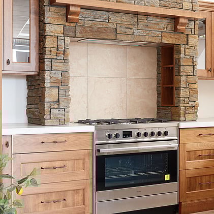 Elegant kitchen design with dark oak cabinetry and minimalist wood accents, presented in Barrett Joinery's Timaru showroom, highlighting their expertise in custom joinery and premium finishes.