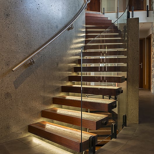 Custom-built staircases with precision craftsmanship, including straight and curved designs by Barrett Joinery.