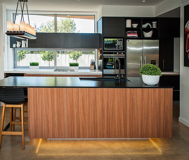 Spacious modern family kitchen with a large island and integrated appliances, showcasing kitchen design by Barrett Joinery.