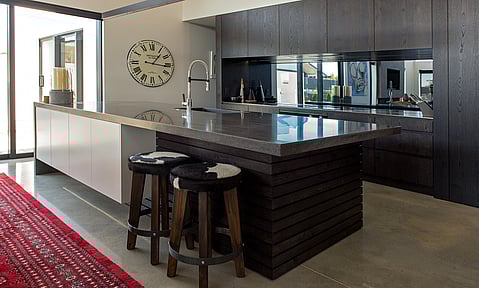 Polished concrete floors complementing the industrial design, with custom joinery by Barrett Joinery.