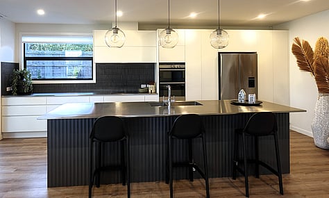 Central island with seating, adding practicality to the modern kitchen by kitchen designer Timaru.