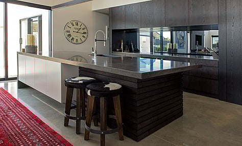 Sleek kitchen appliances integrated into the industrial design, enhancing both form and function, crafted by Barrett Joinery.