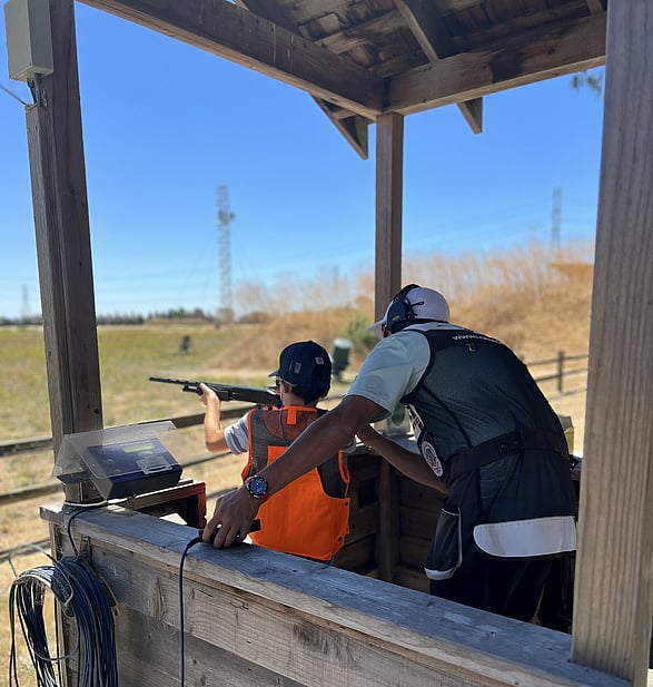Kade coaching young shooter