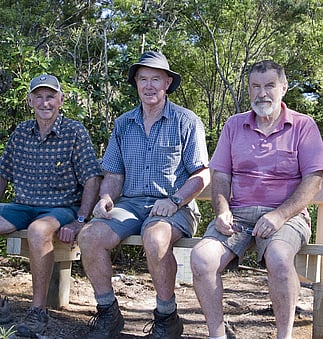 Rings Beach Wetland Group volunteers Ian Goodall, Ian McDonald and Ian Patrick sitting on a newly erected seat in the bush