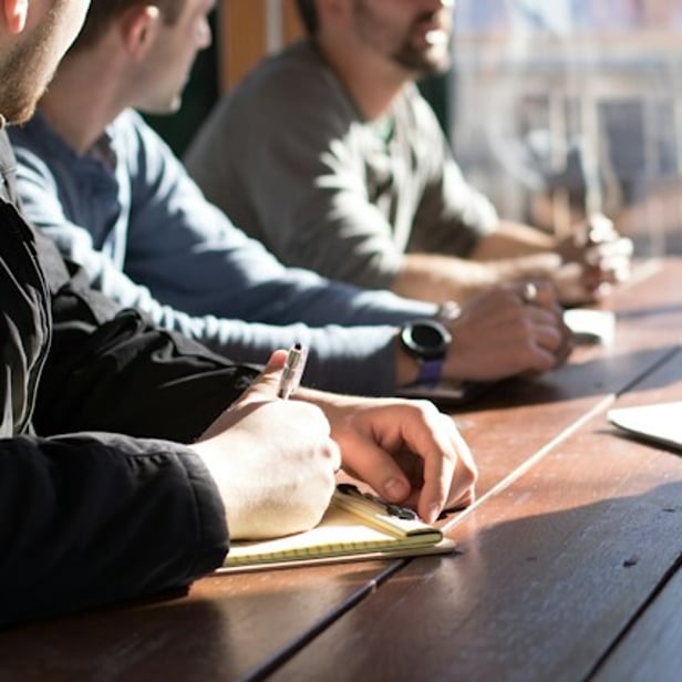 Three staff members at table together.