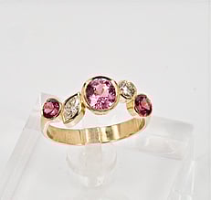 Diamond ring with pink spinels
