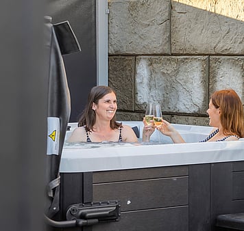 Guests enjoying wine in spa pools in accommodation in Taupo