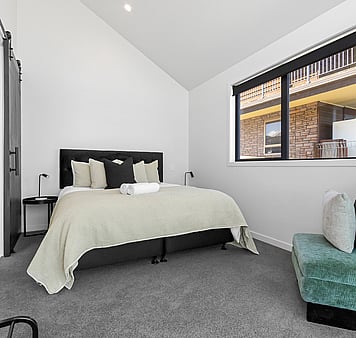 King sized bed in modern bedroom accommodation in Lake Taupo, New Zealand