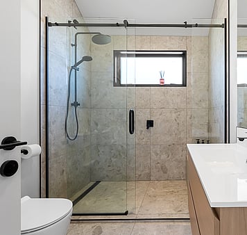 Modern bathroom with shower, toilet and laundry facilities