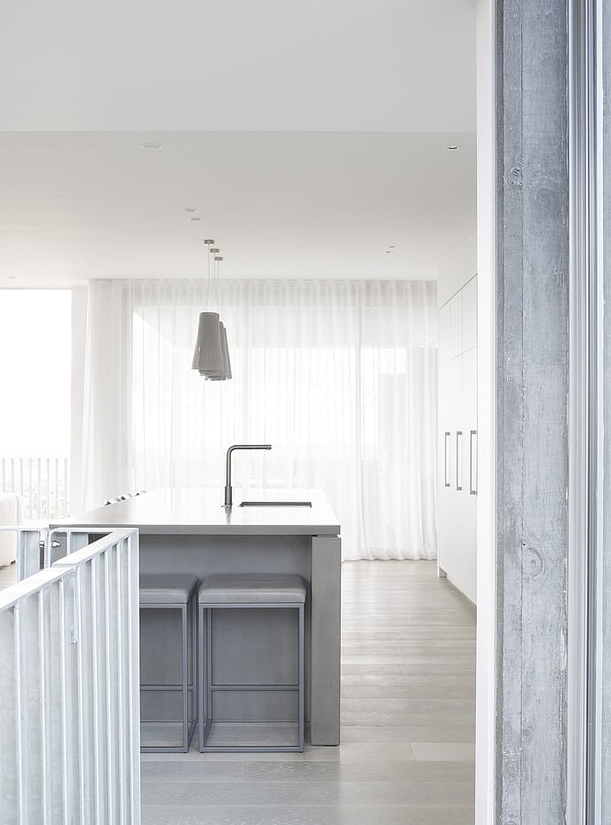 Grey polished kitchen island with crisp white cabinetry