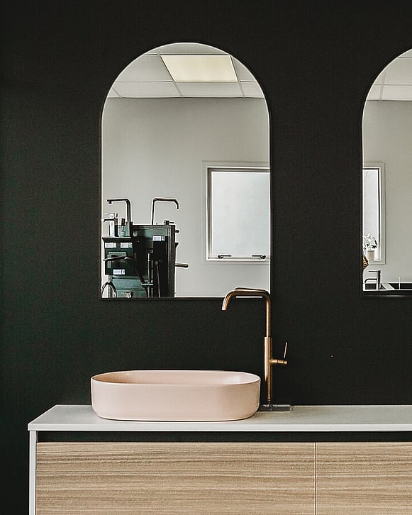Image from Gane Plumbing's showroom. Basin mixer and pink basin with arch mirror. Te Awamutu, New Zealand.