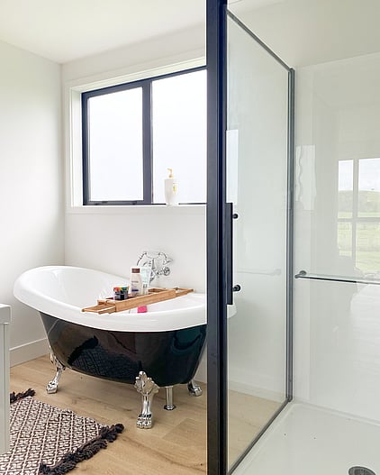 Bathroom with black claw foot freestanding bath