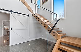 Floating oak staircase leading to main living area