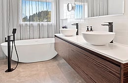 Master bathroom with double vanity and freestanding bath