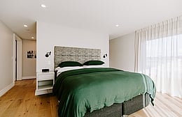 Master suite corridor into bedroom with hidden wardrobe