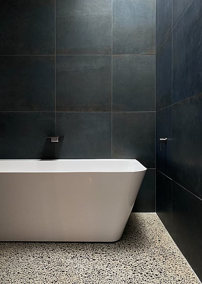 bathroom with polished concrete floors and freestanding bath