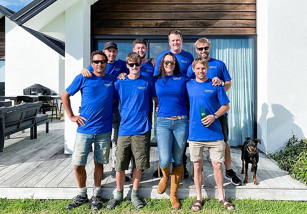 Harrison Lane team standing in front of country home deck