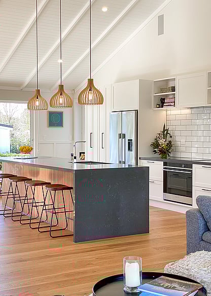 Raked ceiling over living area with decorative rafters