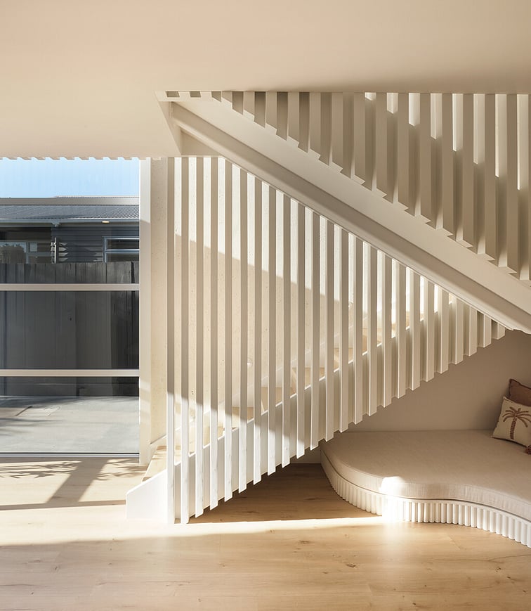 An enclosed outdoor kitchen area with pizza oven, kitchen bench with bar fridge.