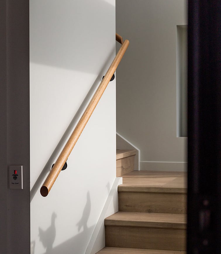 An enclosed outdoor kitchen area with pizza oven, kitchen bench with bar fridge.