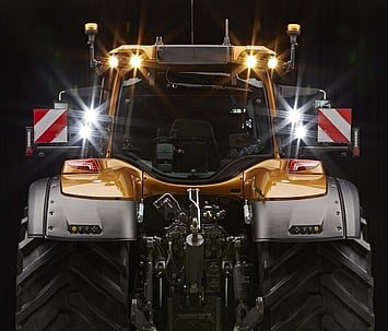 Rear view of the Valtra S Series tractor illuminated at night, highlighting the LED driving lights and robust rear linkage system.