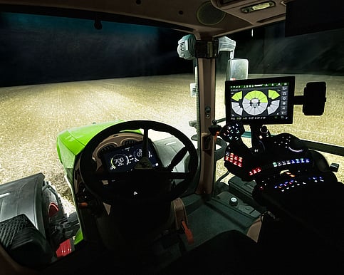 Fendt 800 Vario Gen5 tractor in a field at night, in the cab, showing the controls