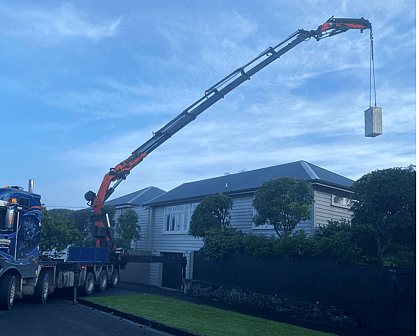 Photo of hiab crane truck lifting structure onto residential property
