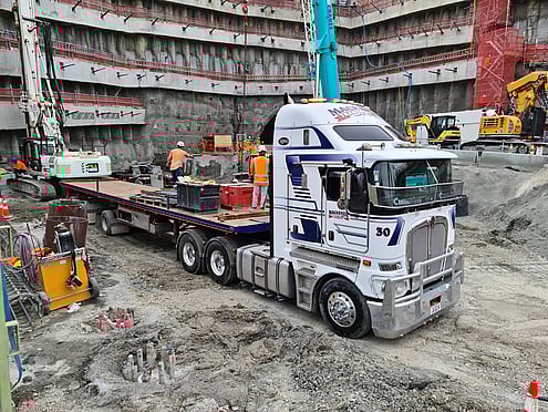 Photo of Mackenzie Transport crane truck lifting a freight container