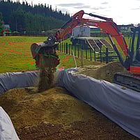Drainpro digging lifting dirt onto truck