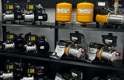 Shelf with a selection of house and farm water pumps on it