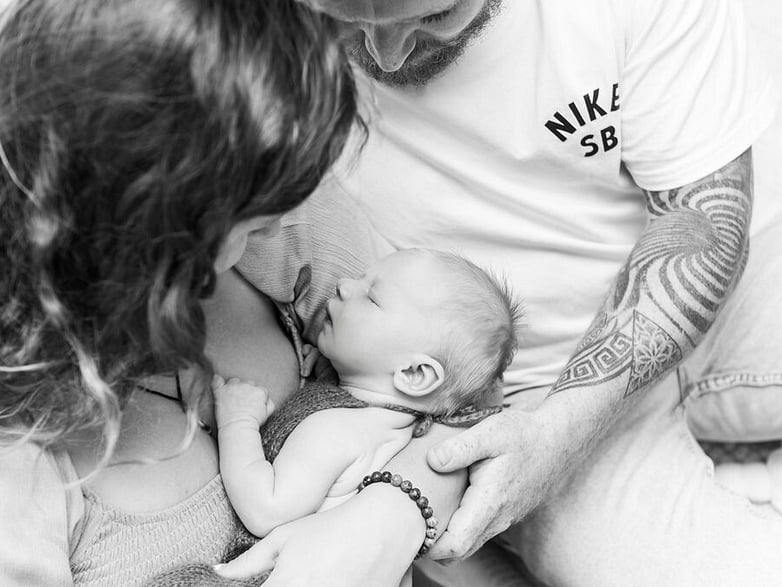 Mum and Dad with newborn baby in black and white
