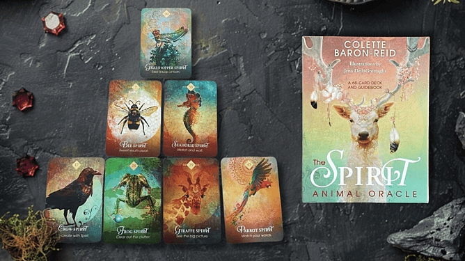 The Spirit Animal Oracle Deck with a spread laid out on a moss and gem background