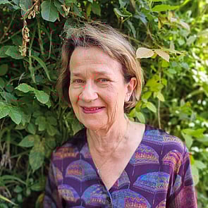 Photo of man with short brown hair in front of brick wall