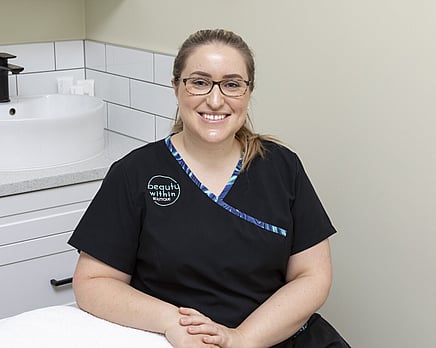 A picture of Joelle sitting in the Beauty within Salon