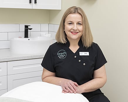 A picture of Paula sitting in the Beauty within Salon