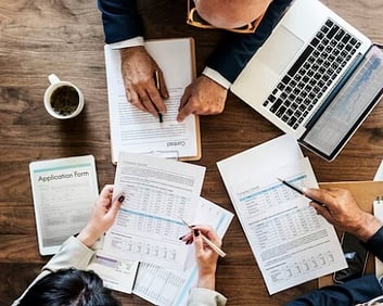 Knowledgeable people looking at paperwork