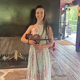 Erica and her violin ready to play at an event.