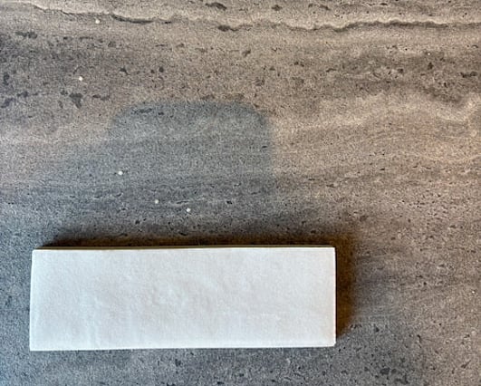 Dark grey tiles and textured cream tiles