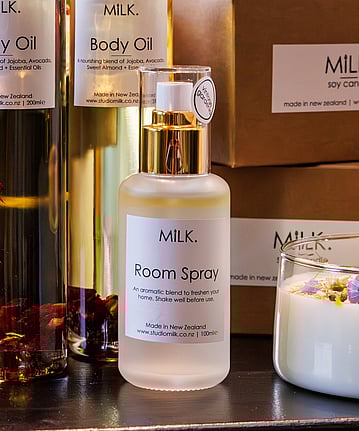 A small opaque glass bottle of scented room spray.