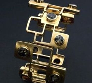 A models hands adorned with Jane Sutherlands handmade silver jewellery.