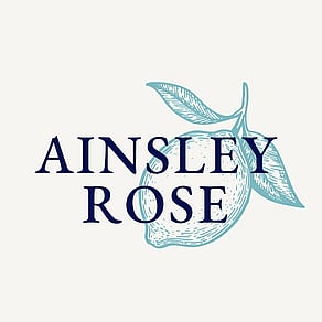An illustrated logo for Ainsley Rose with text over a hand drawn lemon.