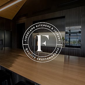 Fiordland Kitchens and Joinery logo over a background image of a kitchen.