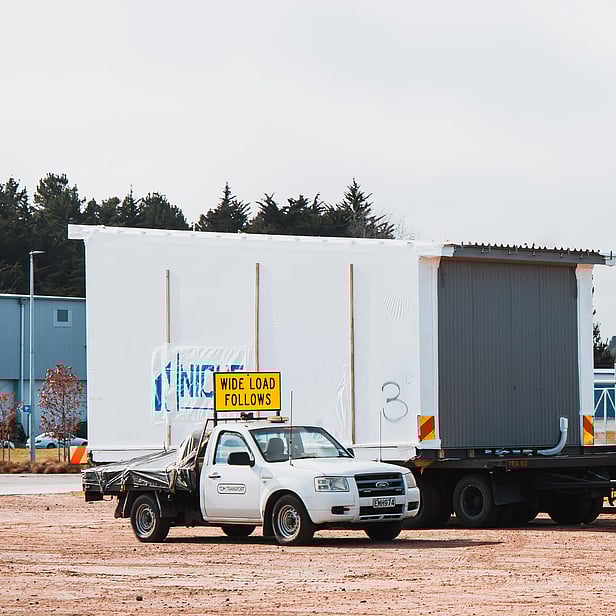TDM Transport staff member moving modular homes in Hamilton, New Zealand