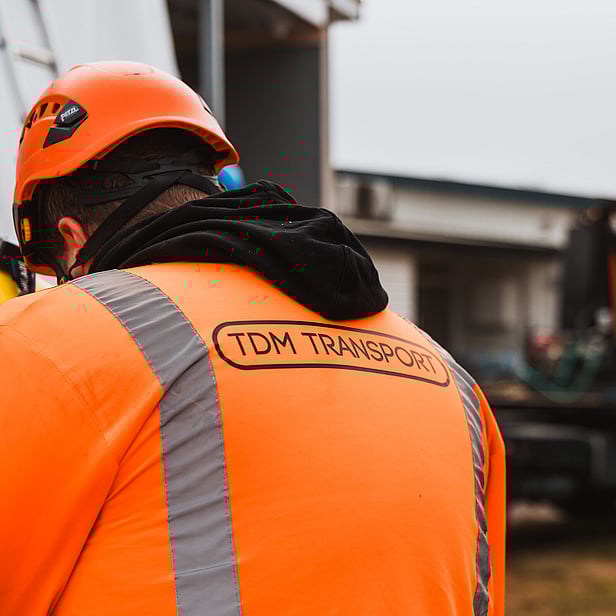 TDM Transport staff member moving modular homes in Hamilton, New Zealand