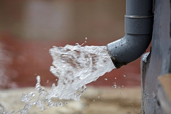 water pouring from a downpipe